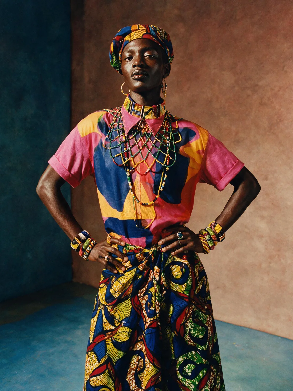 An editorial fashion portrait with West African textile patterns and beadwork